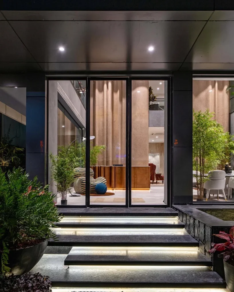 The Galleca entrance at night, lit steps leading to the glass doors on Road No. 12
